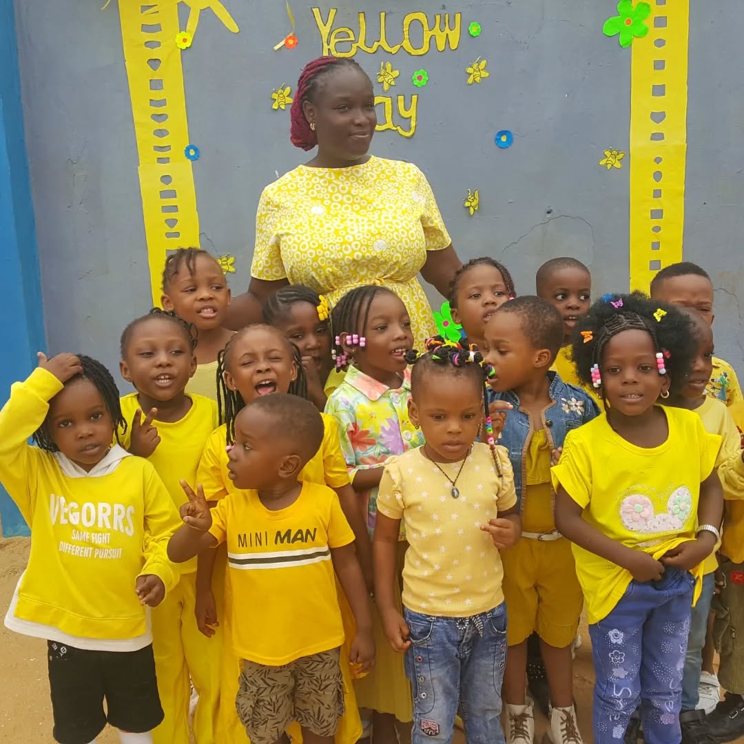 Montessori pupils and their teacher dressed in yellow for Yellow Day