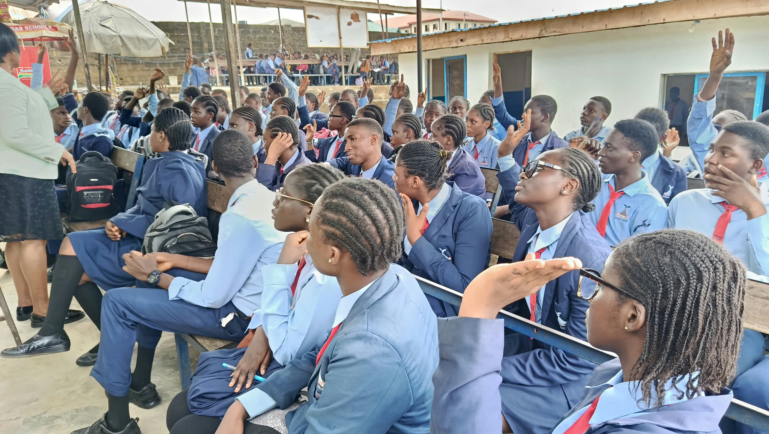 Students raising their hands during a Guidance & Counselling session